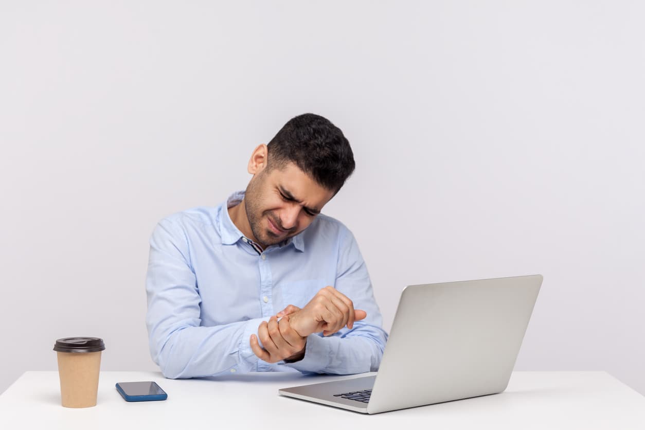 employee sitting office workplace with laptop